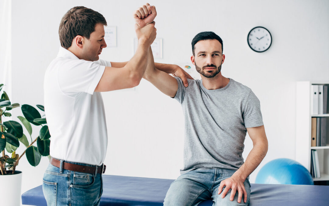 chiropractor adjusting a patient before recording the visit in an ehr system. Learn the differences between ehr and emr