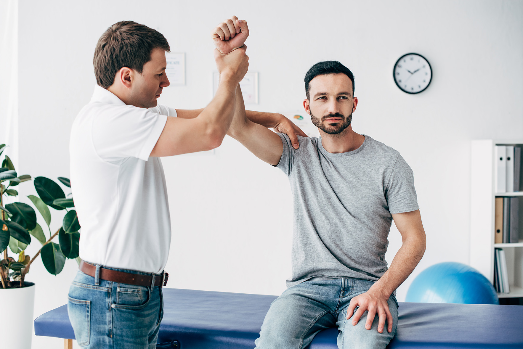 chiropractor adjusting a patient before recording the visit in an ehr system. Learn the differences between ehr and emr