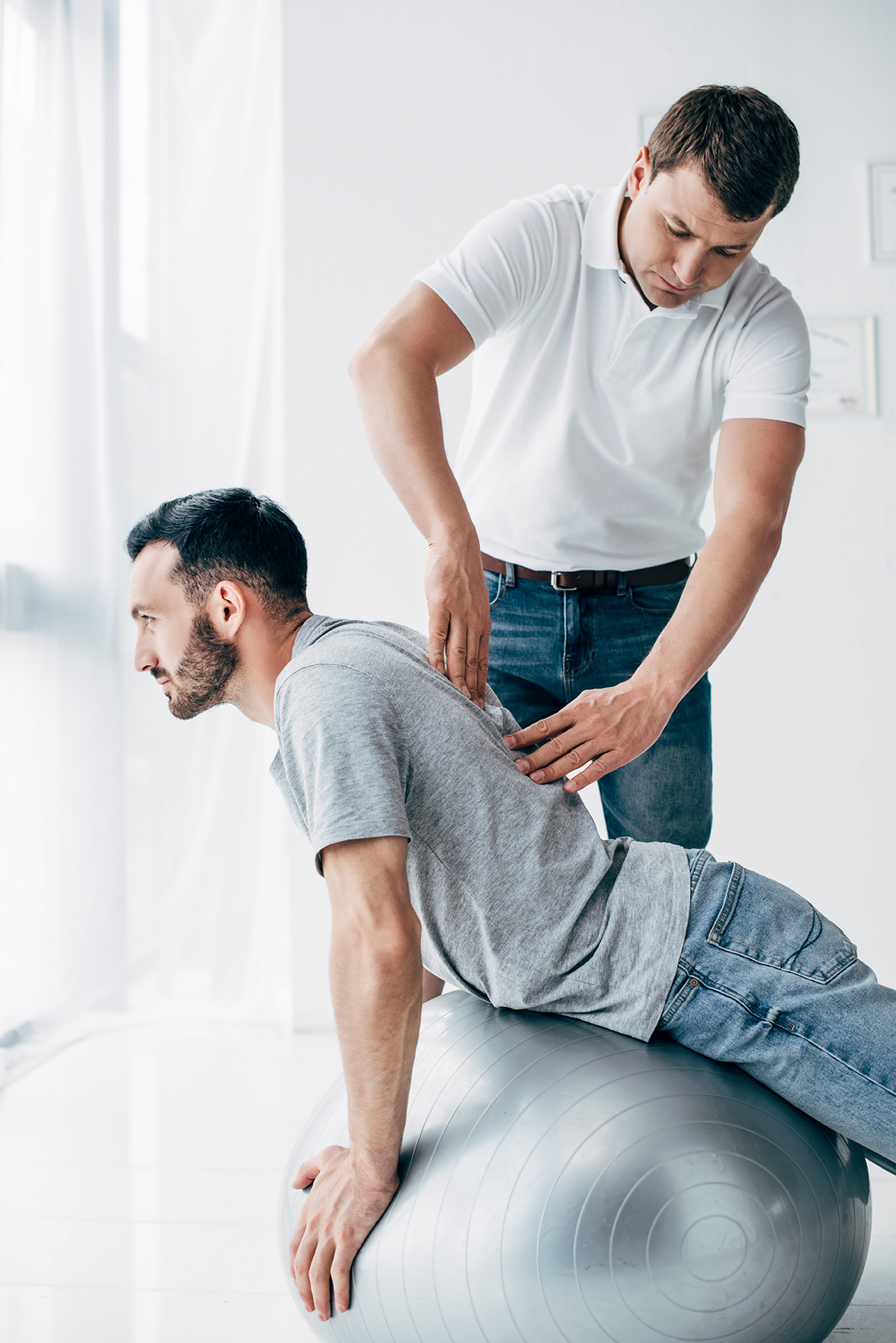 chiropractor adjusting a patient before recording the visit in an ehr system. Learn the differences between ehr and emr