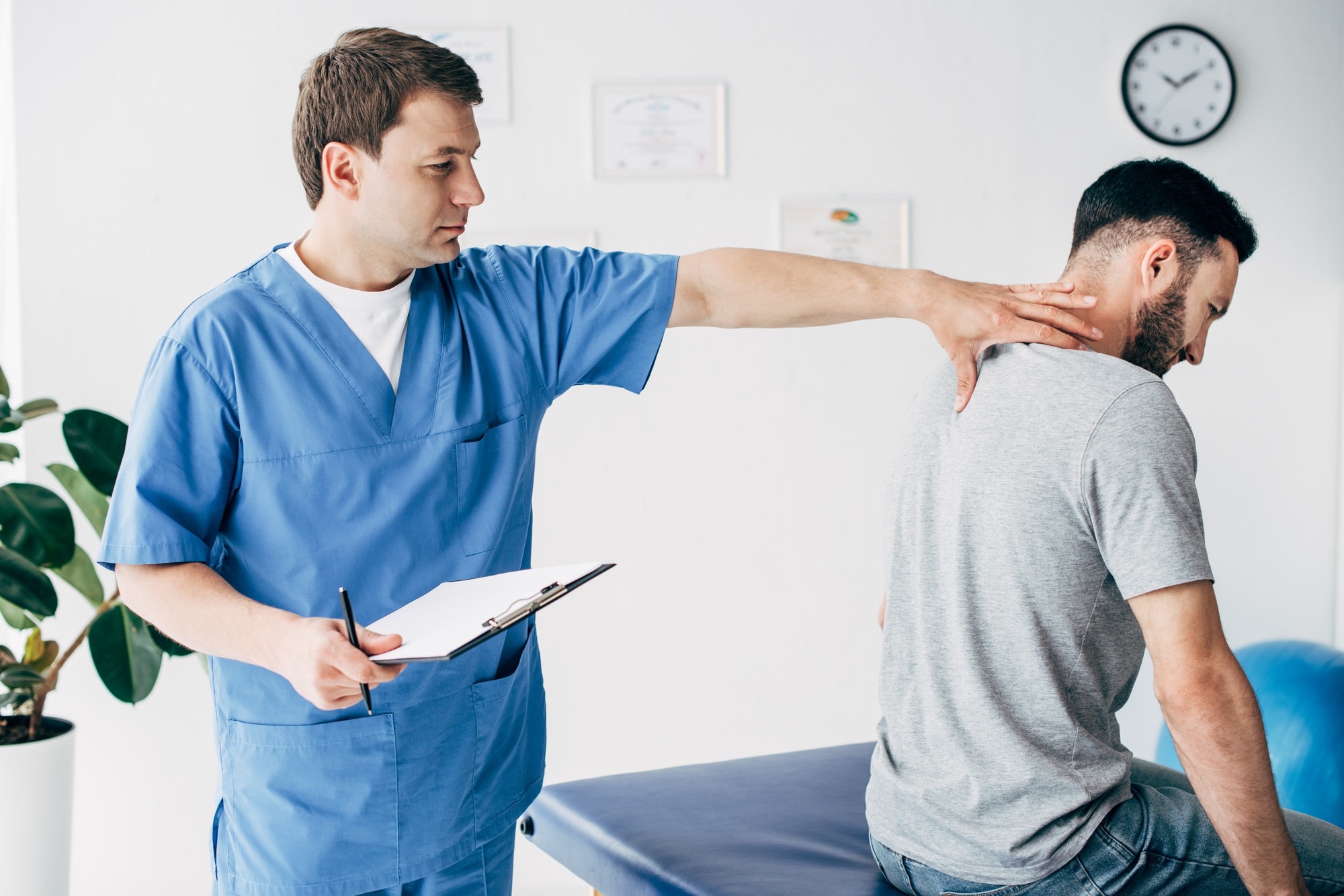 chiropractor with diagnosis and pen massaging neck of man in hospital