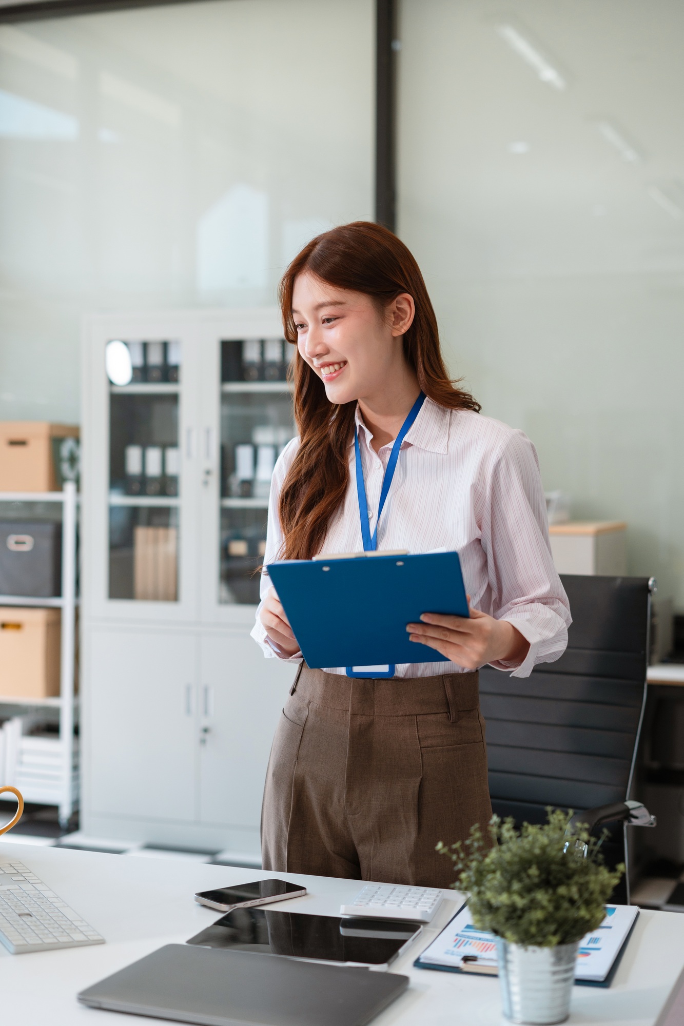 Successful business woman standing front at the desk.