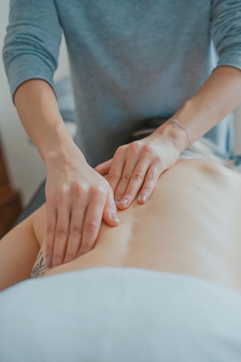 chiropractor massaging patient's back - chiropractic startup guide